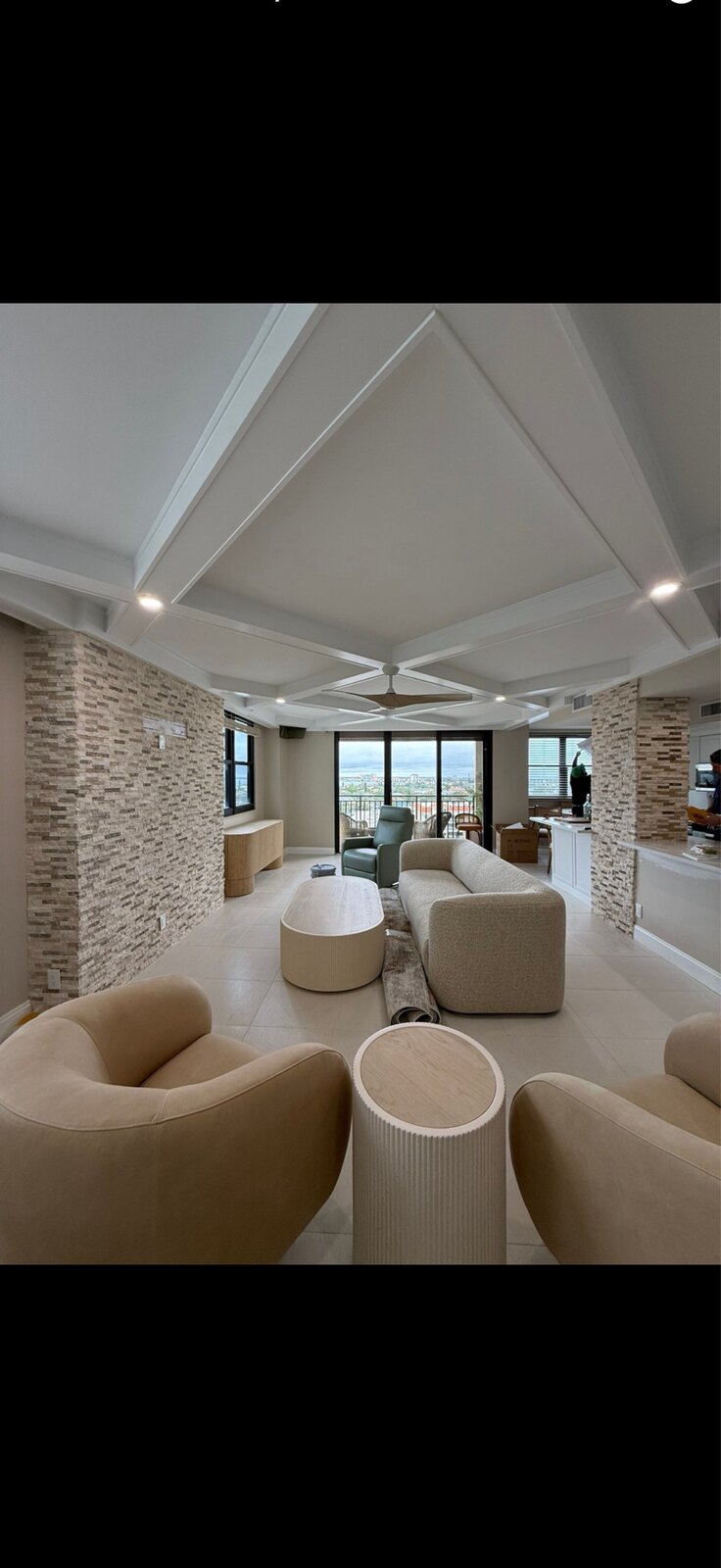 Upscale Gulf-front condo remodel with coffered ceiling and stacked-stone columns on St. Pete Beach by C&A Contracting
